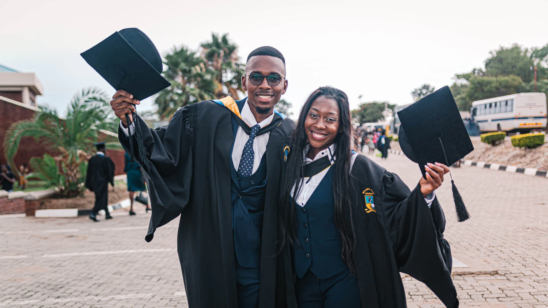 Two African graduates celebrating after studying abroad